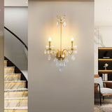 The pearl sconce lit on a wall beside a curved marble staircase