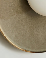 Close view of the glossy taupe glaze and its darker rim