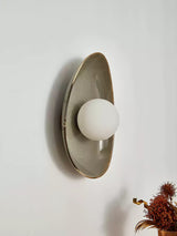 The pebble light seen from the side, showing its curved profile