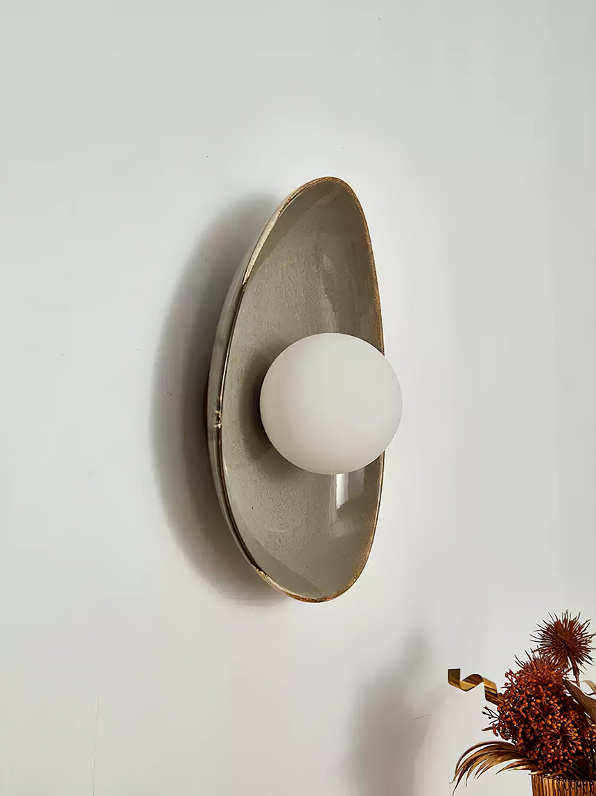 The pebble light seen from the side, showing its curved profile