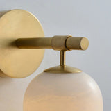 Close view of the gold arm, the knurled joint and the top of the stone shade
