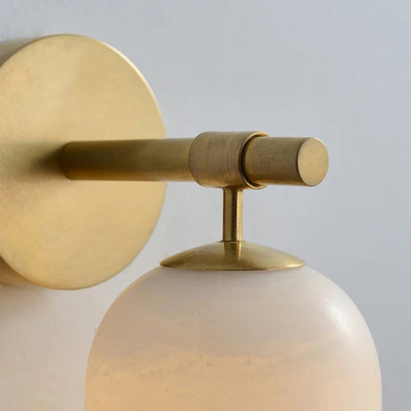 Close view of the gold arm, the knurled joint and the top of the stone shade