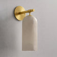The gold version with its stone cylinder, seen against a plain wall