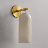 The gold version with its stone cylinder, seen against a plain wall