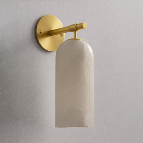 The gold version with its stone cylinder, seen against a plain wall