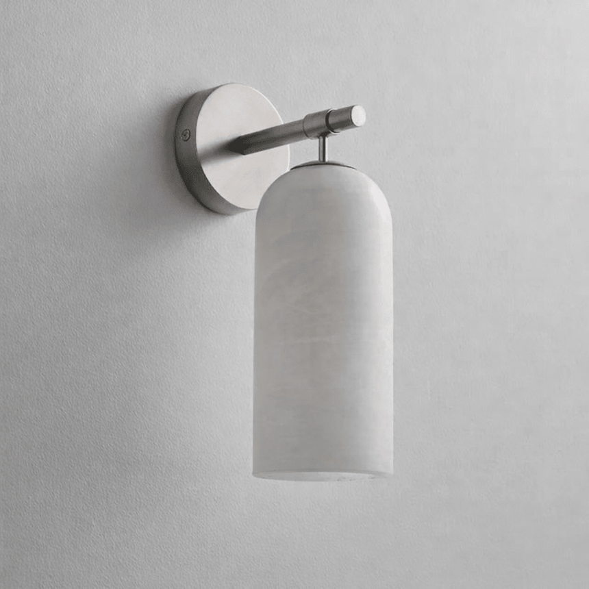 The nickel version with its stone cylinder, seen against a plain wall