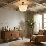 Pleated ceiling light under a coffered ceiling in a room with a wood sideboard
