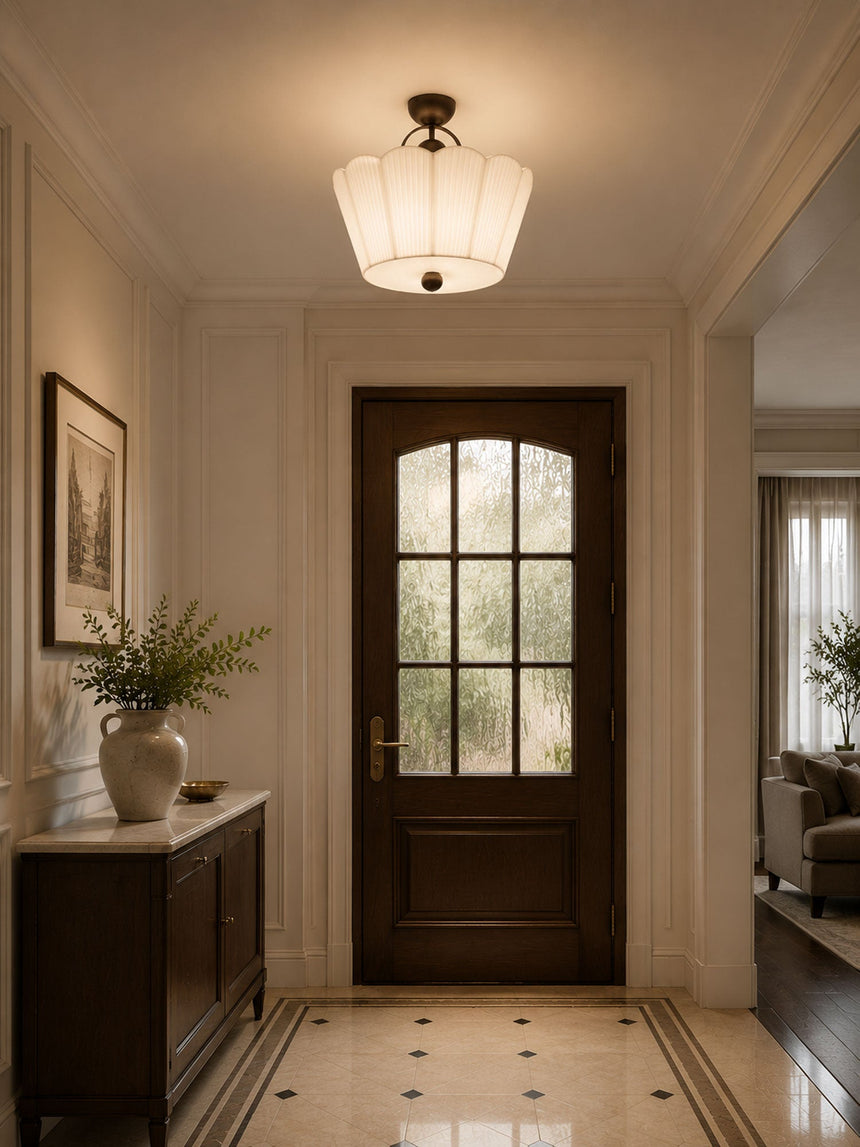 Pleated fabric ceiling light lit in an entry hall with a glazed door and tiled floor