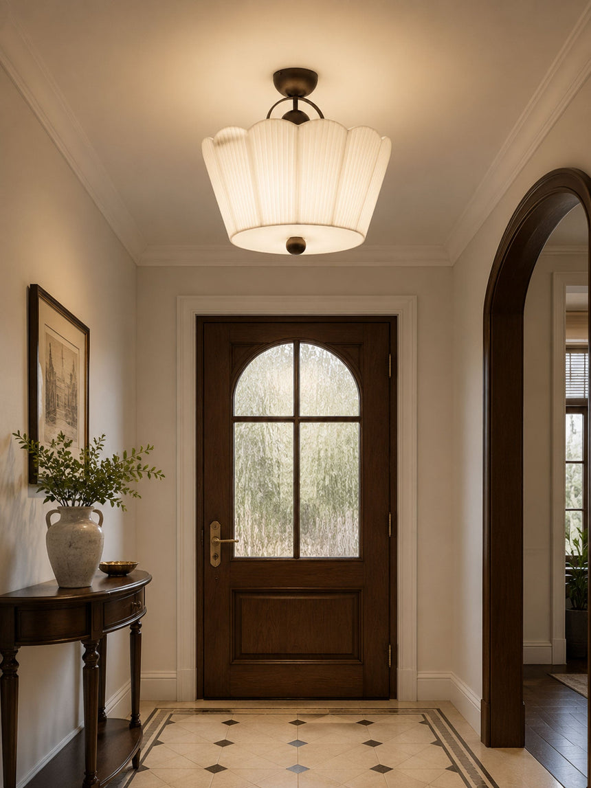Pleated ceiling light in a hallway with an arched doorway and a console table