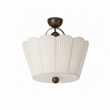Pleated ceiling light seen close up, unlit, showing the scalloped petal outline