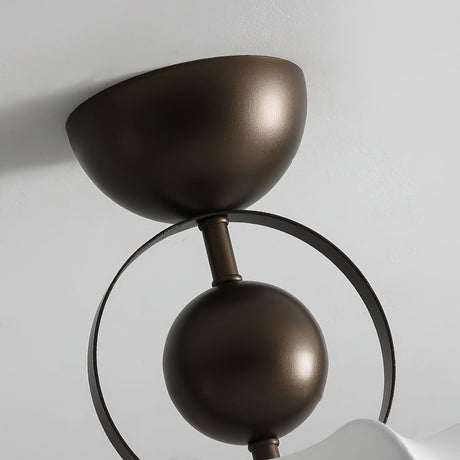 Close view of the bronze canopy, ring and ball detail above the silk shade