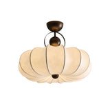 Pleated silk ceiling light lit, shown on its own against a plain background