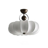 Pleated ceiling light with the white silk shade seen against a plain background