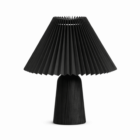 Pleated black shade on a black wood base against a plain white ground
