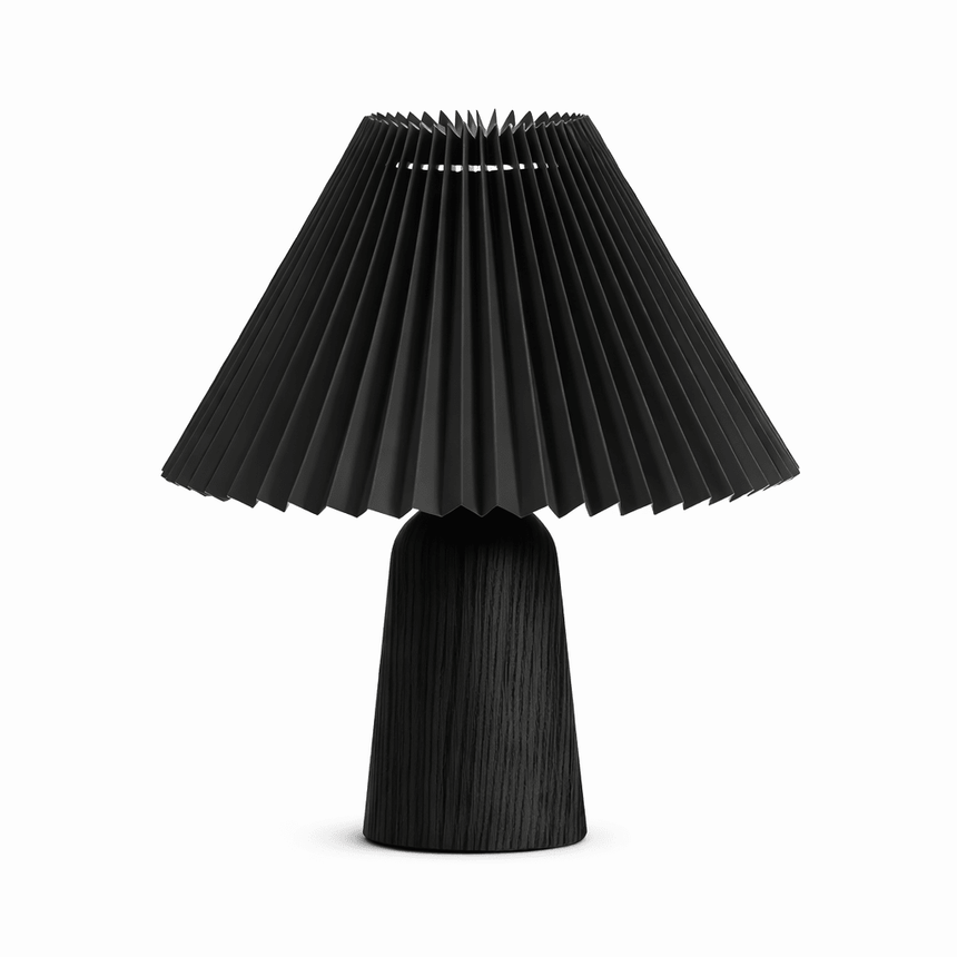 Pleated black shade on a black wood base against a plain white ground