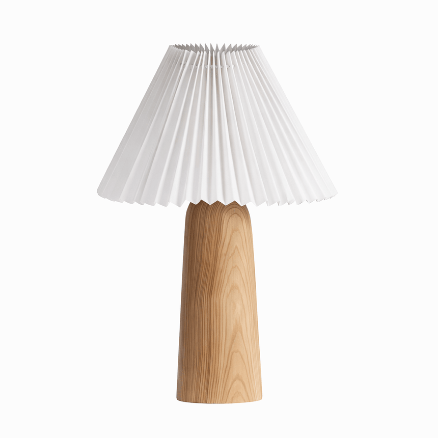 Tall wood base with a wide pleated white shade seen slightly from above