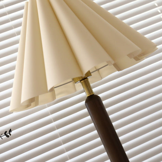 Close view of the knife pleated linen flutes and the gold collar