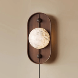Close view of the translucent disc set in the middle of the walnut frame