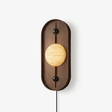 Plug in wall lamp, a stone look disc in a tall walnut frame with a cord
