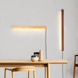 Pine bar lit above a wood table with a stool and two vessels