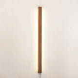 Pine bar lit vertically on a plain wall, seen from straight on