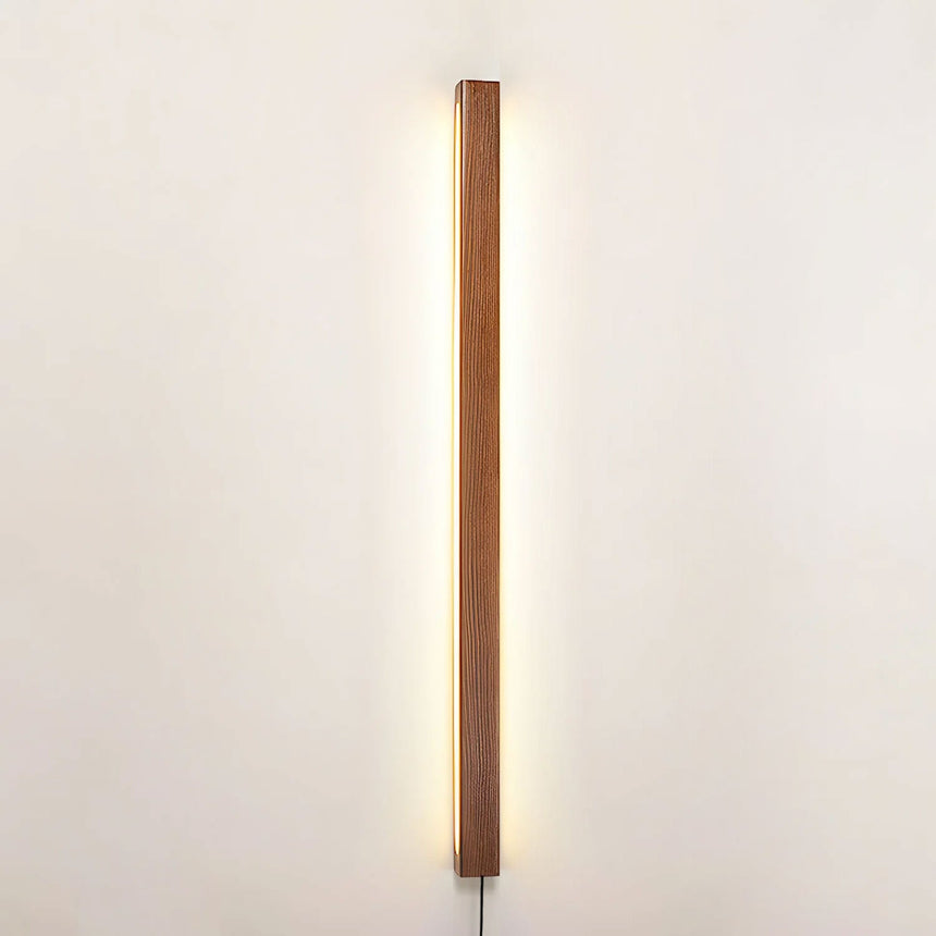 Pine bar lit vertically on a plain wall, seen from straight on