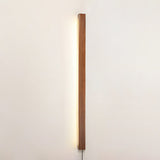 Slim pine bar mounted vertically and lit against a plain pale wall