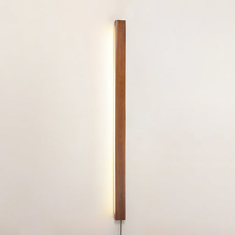Slim pine bar mounted vertically and lit against a plain pale wall