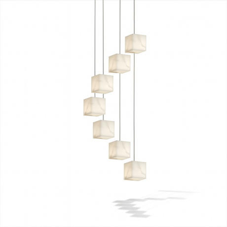 A cascade of unlit alabaster cubes on thin cables at stepped heights