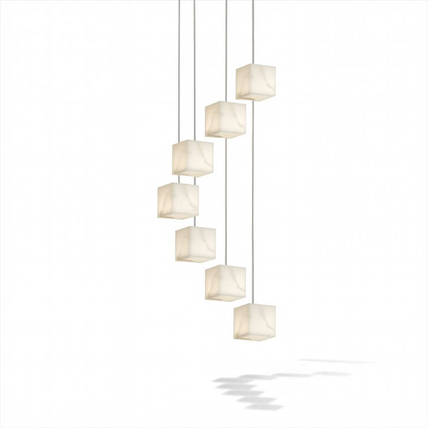 A cascade of unlit alabaster cubes on thin cables at stepped heights