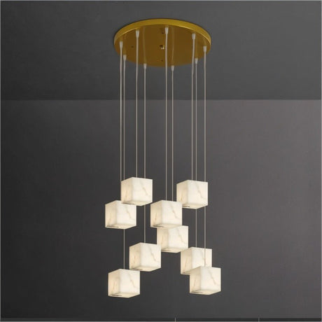 Alabaster cubes hung at staggered heights on cables from a round brass plate
