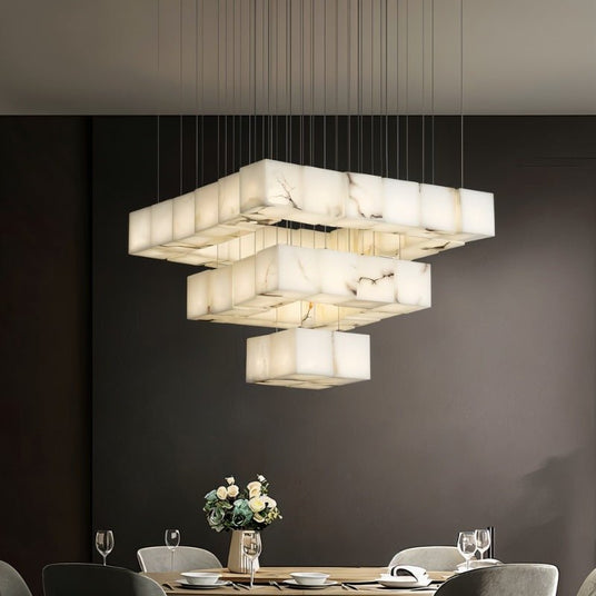 A stacked block of lit cubes above a dining table set for a meal