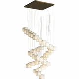 A long spiral of lit alabaster cubes dropping from a square brass plate