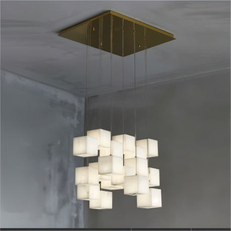 Lit cubes on cables from a square brass plate in a concrete ceiling corner