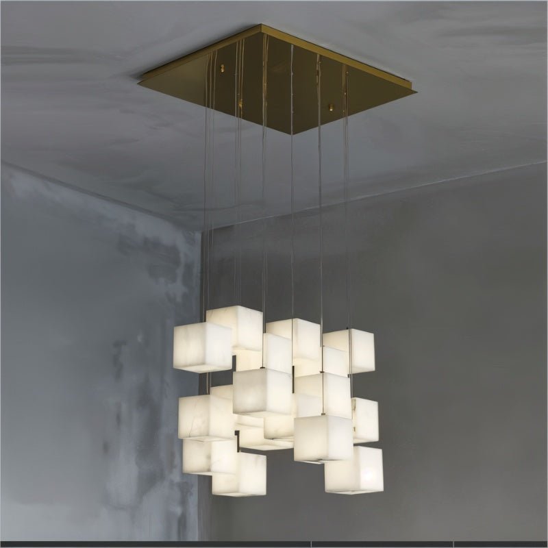 Lit cubes on cables from a square brass plate in a concrete ceiling corner