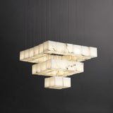 Lit cubes stacked in three square tiers below a square brass plate
