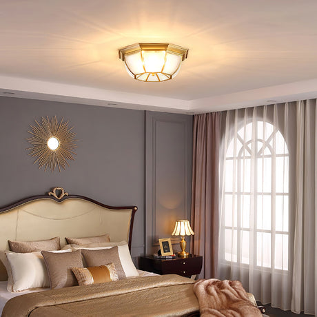 Octagonal brass ceiling light near a tall arched window