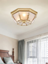 Octagonal brass ceiling light seen from below in a bedroom