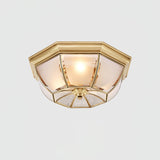 Octagonal brass ceiling light seen from the side, unlit