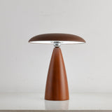 Portable table lamp on a cone base against a plain ground