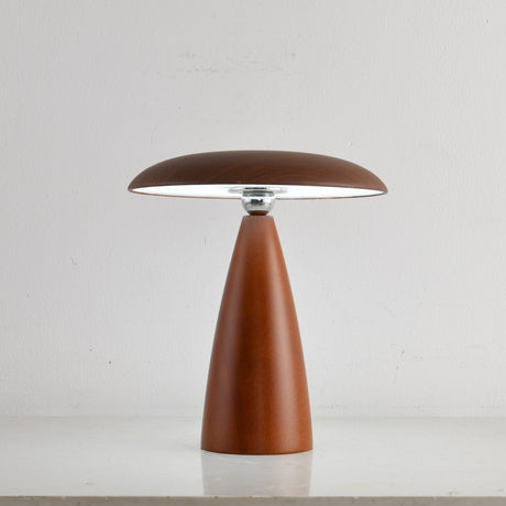 Portable table lamp on a cone base against a plain ground