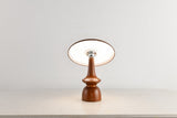 Portable table lamp on a spindle base with the disc lit