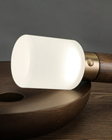 Close view of the lit acrylic cap above the brass collar of the lamp