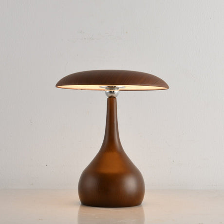 Portable table lamp on a teardrop base with the disc lit