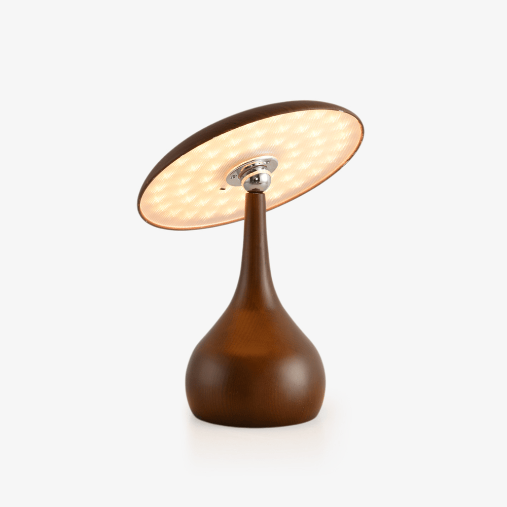 Portable table lamp with a tilting disc on a teardrop wood base