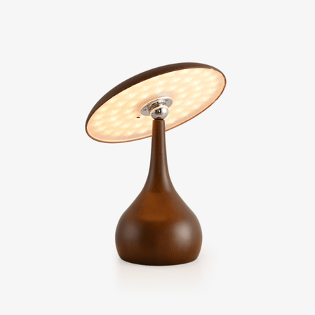 Portable table lamp with a tilting disc on a teardrop wood base