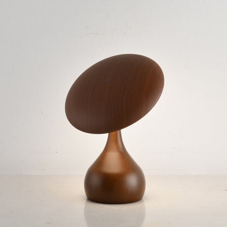 Portable table lamp on a teardrop base, disc tilted over