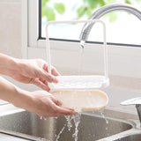 Dishcloth holder mounted near kitchen sink
