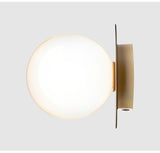 Globe Light Fixture Beside Fireplace Mantel