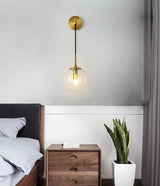 Black wall sconce mounted above a desk